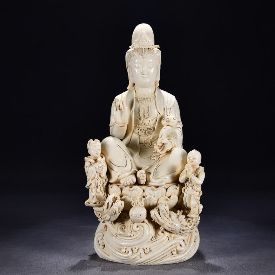 A statue of Guanyin in the Ming Dynasty He Chaozong style, white porcelain, golden boy and jade girl: Ming Dynasty He Chaozong style Dehua white porcelain golden boy and jade girl Ruyi Guanyin seated statue SIZE: H:51cm W:25cm (The Dimensions Of All Batches Are Manually Measured.If You Need More Detai