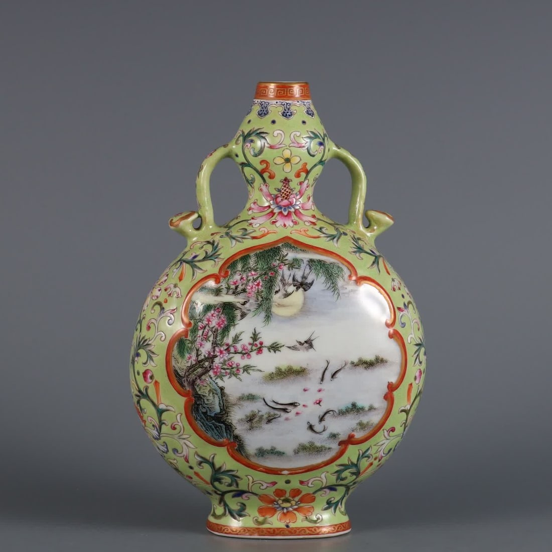 A Qing Dynasty Qianlong year green pastel window flower and bird pattern ruyi ear flat bottle: Qing Dynasty Qianlong year green pastel window flower and bird pattern ruyi ear flat vase SIZE: H: 20.5cm Belly diameter 12.5cm MouthD: 2cm (The Dimensions Of All Batches Are Manually Measured.If You 