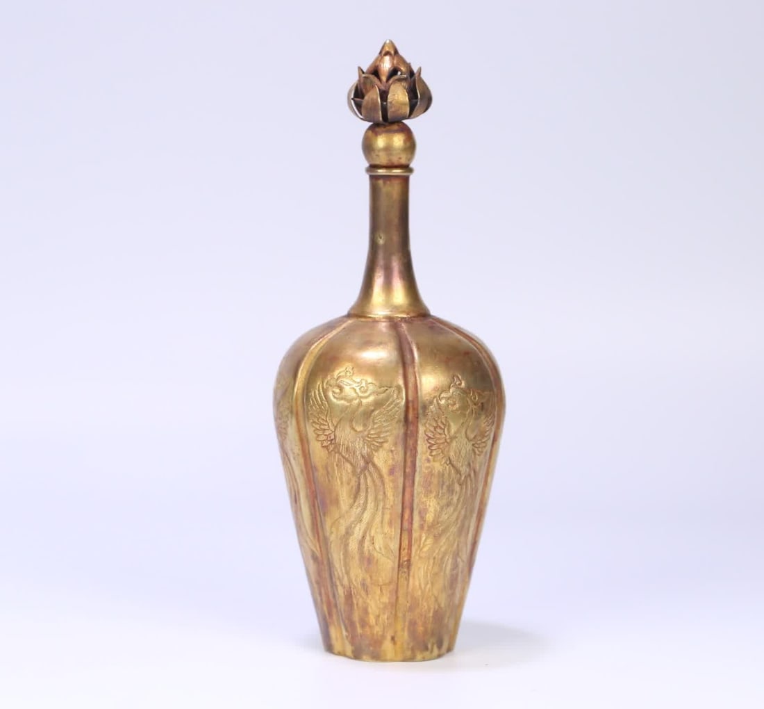 A Tang Dynasty copper gilt lotus button phoenix pattern melon edge bottle: Tang Dynasty copper gilt lotus button phoenix pattern melon edge bottle SIZE: 18.5x7cm W:226g (The Dimensions Of All Batches Are Manually Measured.If You Need More Detailed Information, Please Contact