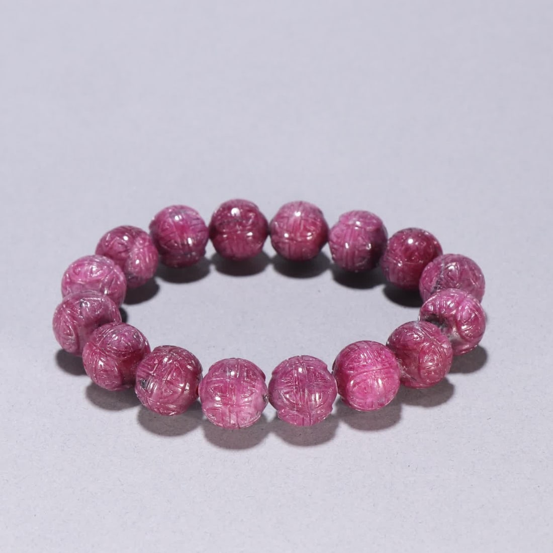 A Qing Dynasty ruby carved longevity pattern bracelet: Qing Dynasty ruby carved longevity pattern bracelet SIZE: Bead diameter 1.3cm W: 68.1g (The Dimensions Of All Batches Are Manually Measured.If You Need More Detailed Information, Please Contact Our Cu