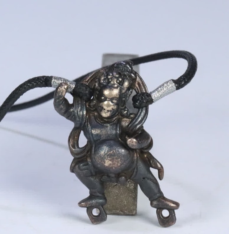 A Qing Dynasty Tibetan copper black God of Wealth pendant: Qing Dynasty Tibetan copper black God of Wealth pendant SIZE: 5.7x3.11cm W:55.6g (The Dimensions Of All Batches Are Manually Measured.If You Need More Detailed Information, Please Contact Our Customer