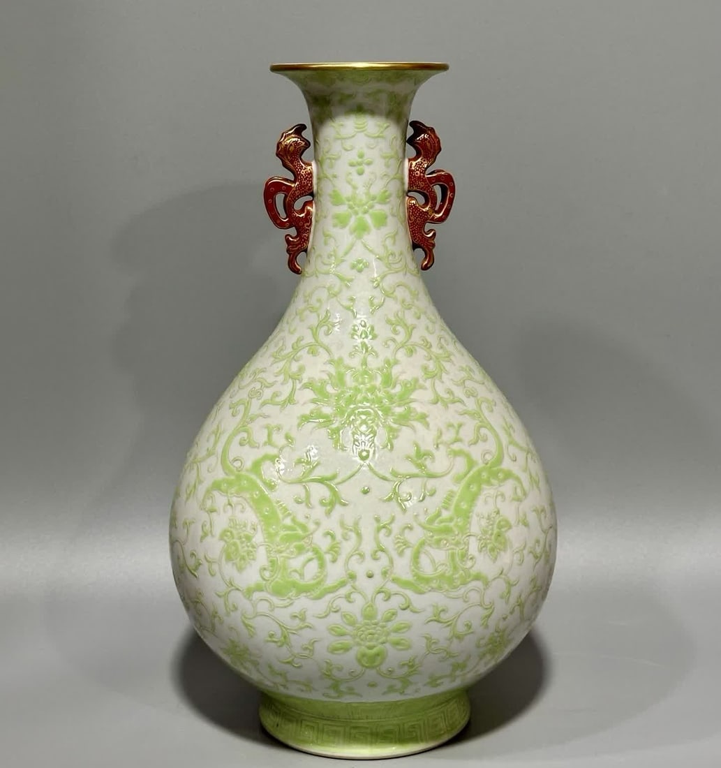 A green entwined lotus pattern dragon ear jade pot spring vase made in the Qianlong period of the: Qianlong year of the Qing Dynasty green color entwined lotus pattern dragon ear jade pot spring vase SIZE: H: 30.9cm MouthD: 8.3cm Belly diameter 18cm Bottom diameter 10cm (The Dimensions Of All Batch