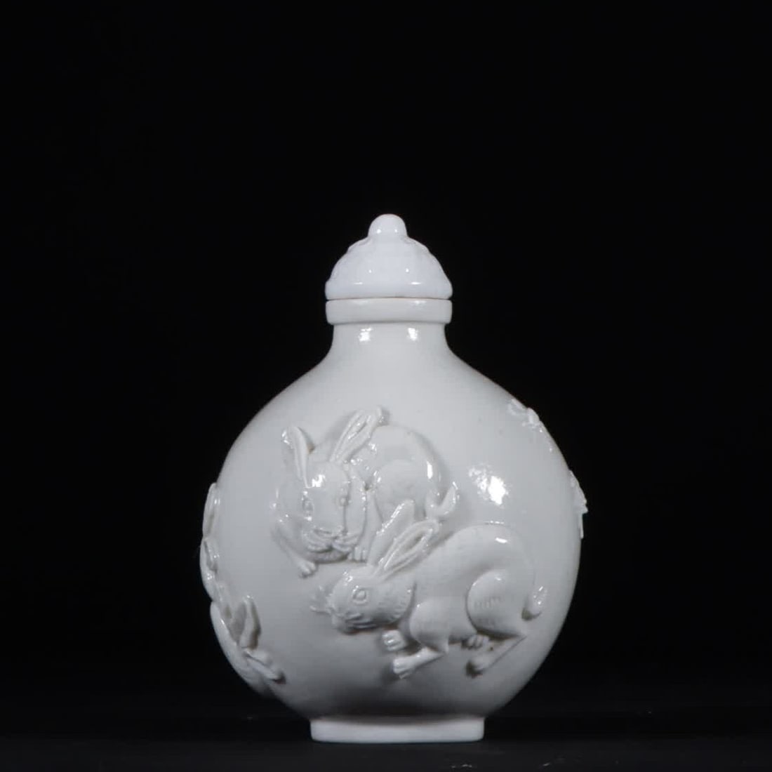 A Qing Dynasty Daoguang white porcelain pile carved rabbit cabbage snuff bottle (1 of 6)