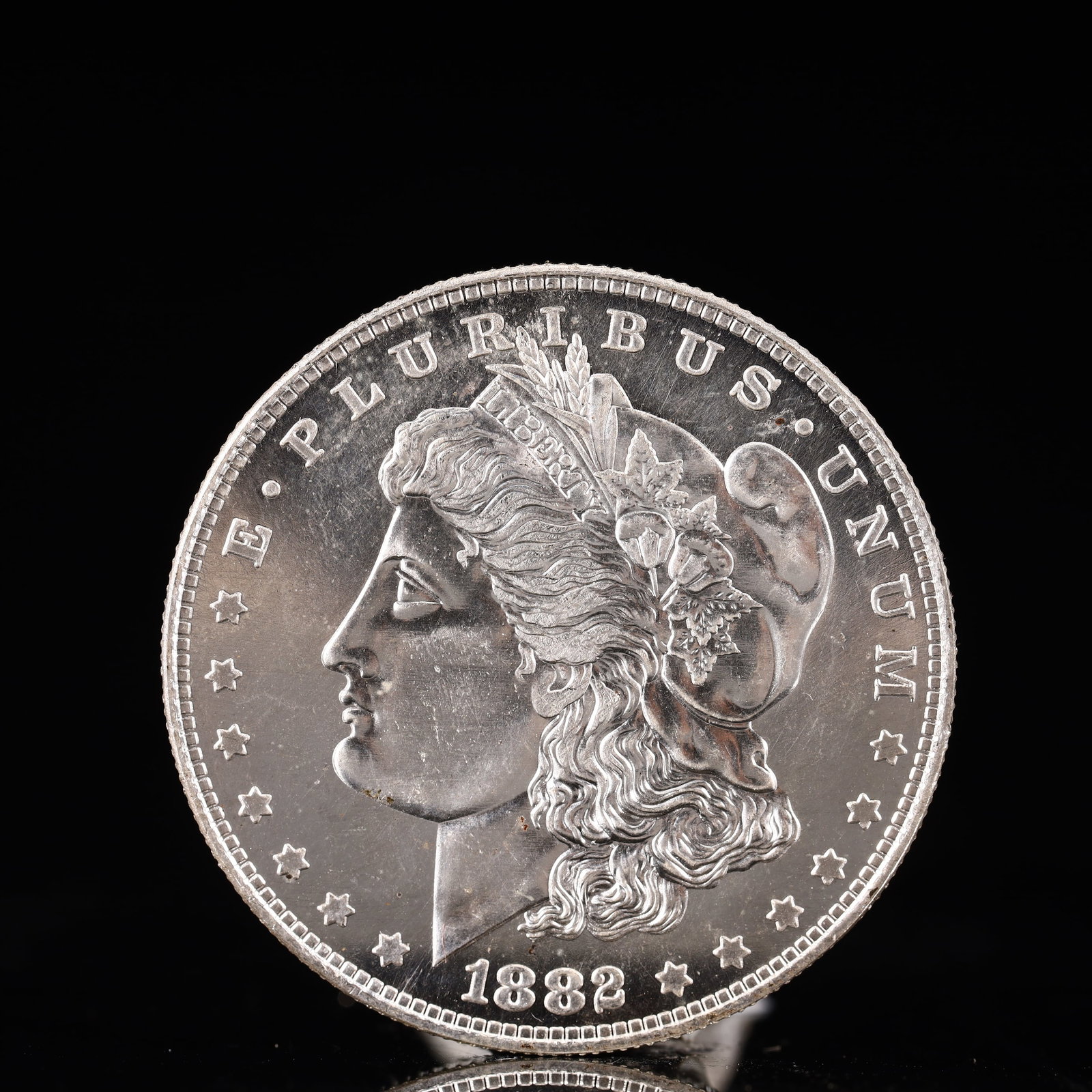 USA Morgan Dollar 1882 Coin: Obv: profile bust with date below and E PLURIBUS UNUM legend and stars around. Rev: eagle with In God we trust above within wreath with UNITED STATES OF AMERICA ONE DOLLAR legend. IN GOD WE TRUST / LI