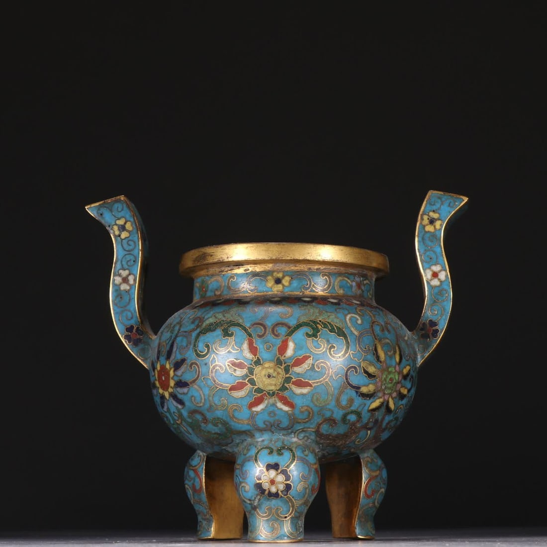 A Qing Dynasty copper-gilt cloisonne entwined lotus pattern three-legged incense burner: Qing Dynasty copper gilt cloisonne entwined lotus pattern three-legged incense burner SIZE: H:11.3cm W:13cm W:434.1g (The Dimensions Of All Batches Are Manually Measured.If You Need More Detailed Info