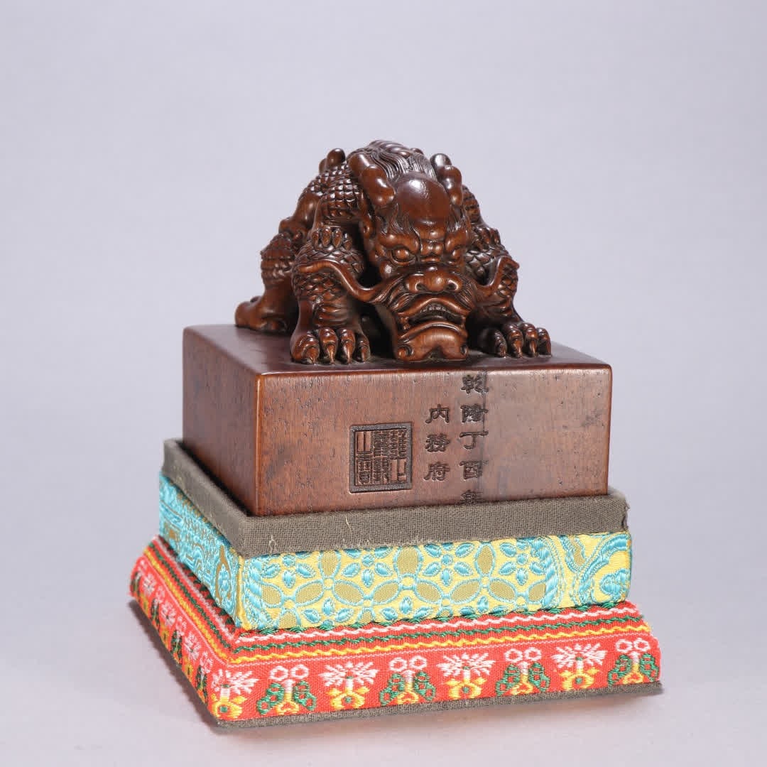 A Qing Dynasty sandalwood dragon button seal (1 of 9)