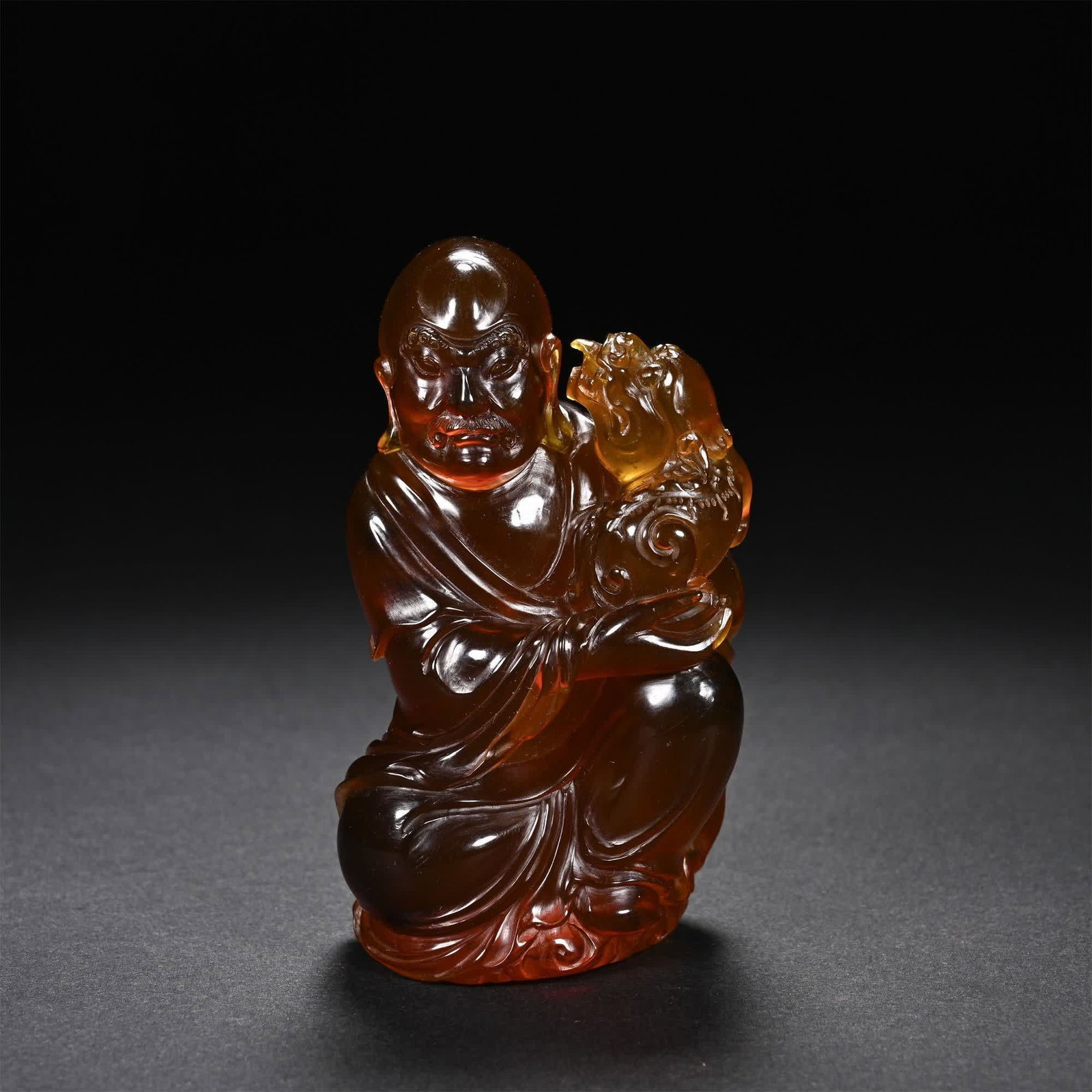 A Qing Dynasty amber lion playing Arhat: Qing Dynasty amber play lion arhat SIZE: L:4.5cm W:3cm H:8cm (The Dimensions Of All Batches Are Manually Measured.If You Need More Detailed Information, Please Contact Our Customer Service Before Bidd