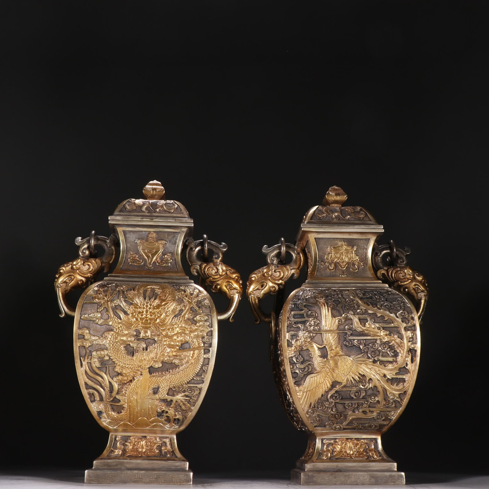 A pair of Qing Dynasty copper gilt gilt silver dragon and phoenix pattern Liang bottles: A pair of copper-gilt gilt silver dragon and phoenix pattern Liangliang bottles in the Qing Dynasty SIZE: H: 35cm W: 15.5cm Single W: 2192.8g (The Dimensions Of All Batches Are Manually Measured.If Yo