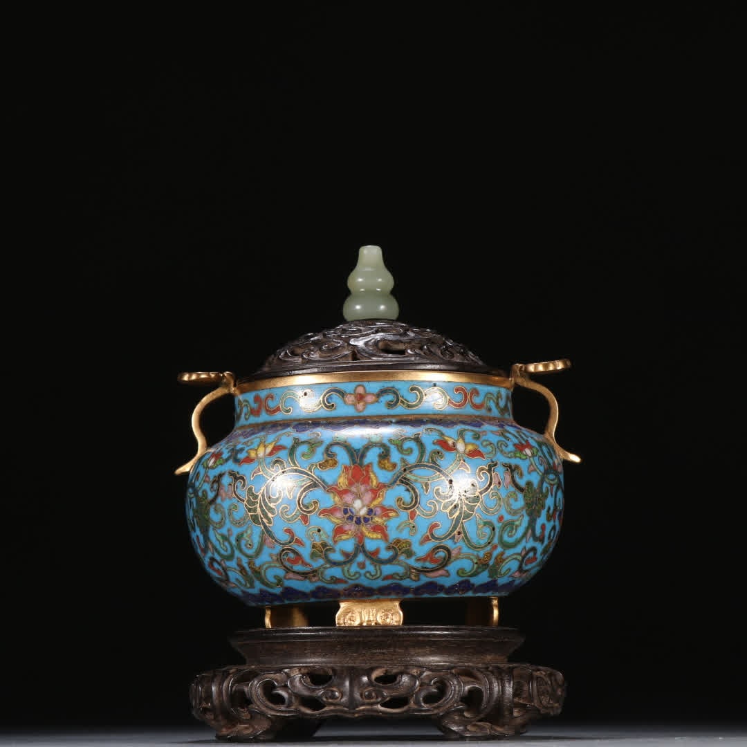 A Qing Dynasty copper gilt cloisonne entwined lotus pattern ruyi ear three-legged aromatherapy stove (1 of 9)