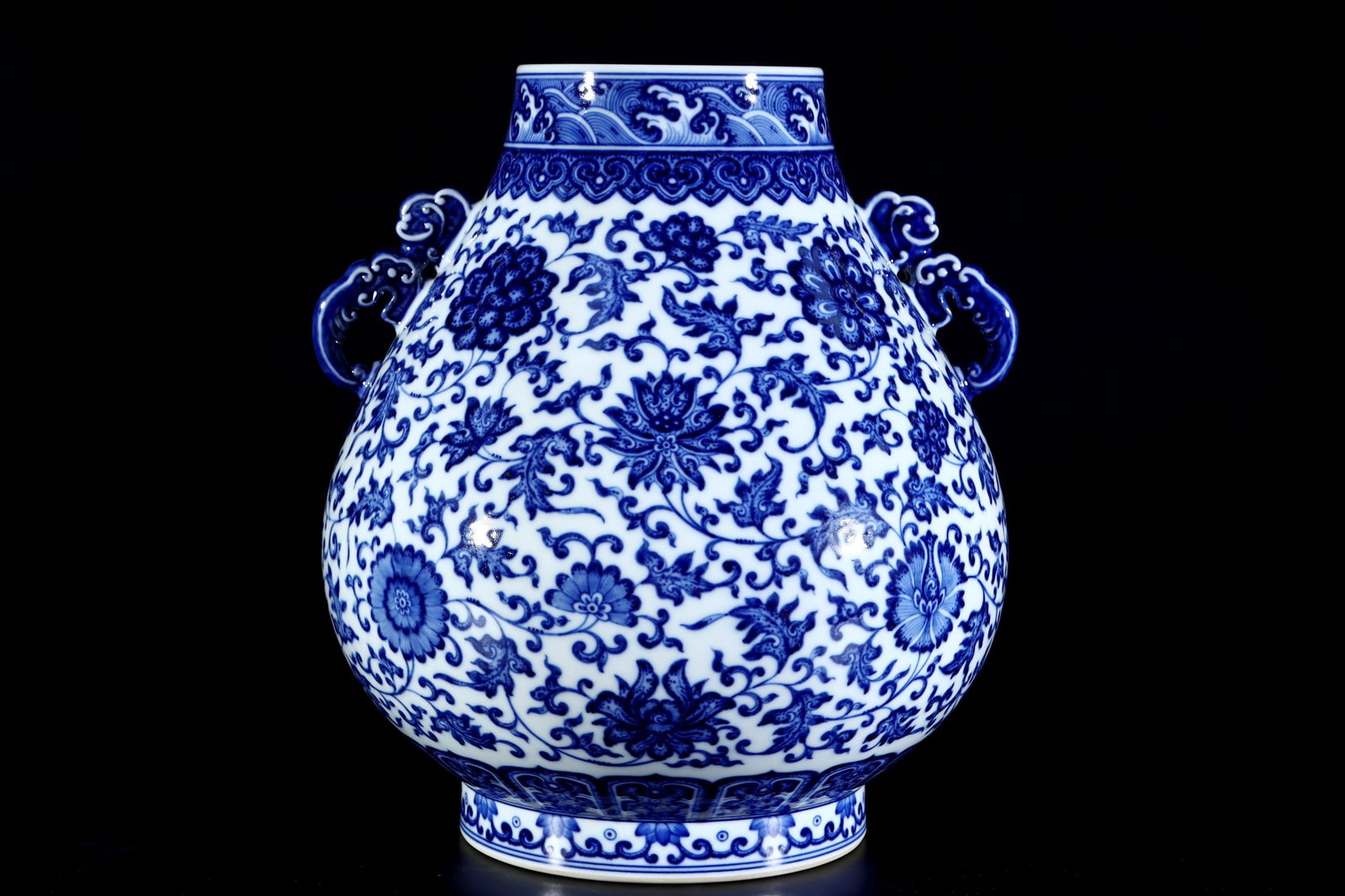 An Exquisite Blue and White Lotus Pattern Seawater Pattern Double-Ears Vase: An Exquisite Blue and White Lotus Pattern Seawater Pattern Double-Ears Vase Qing Dynasty, China Qianlong Six-character Mark Size:30cmx26cm (The Dimensions Of All Batches Are Manually Measured.If You N