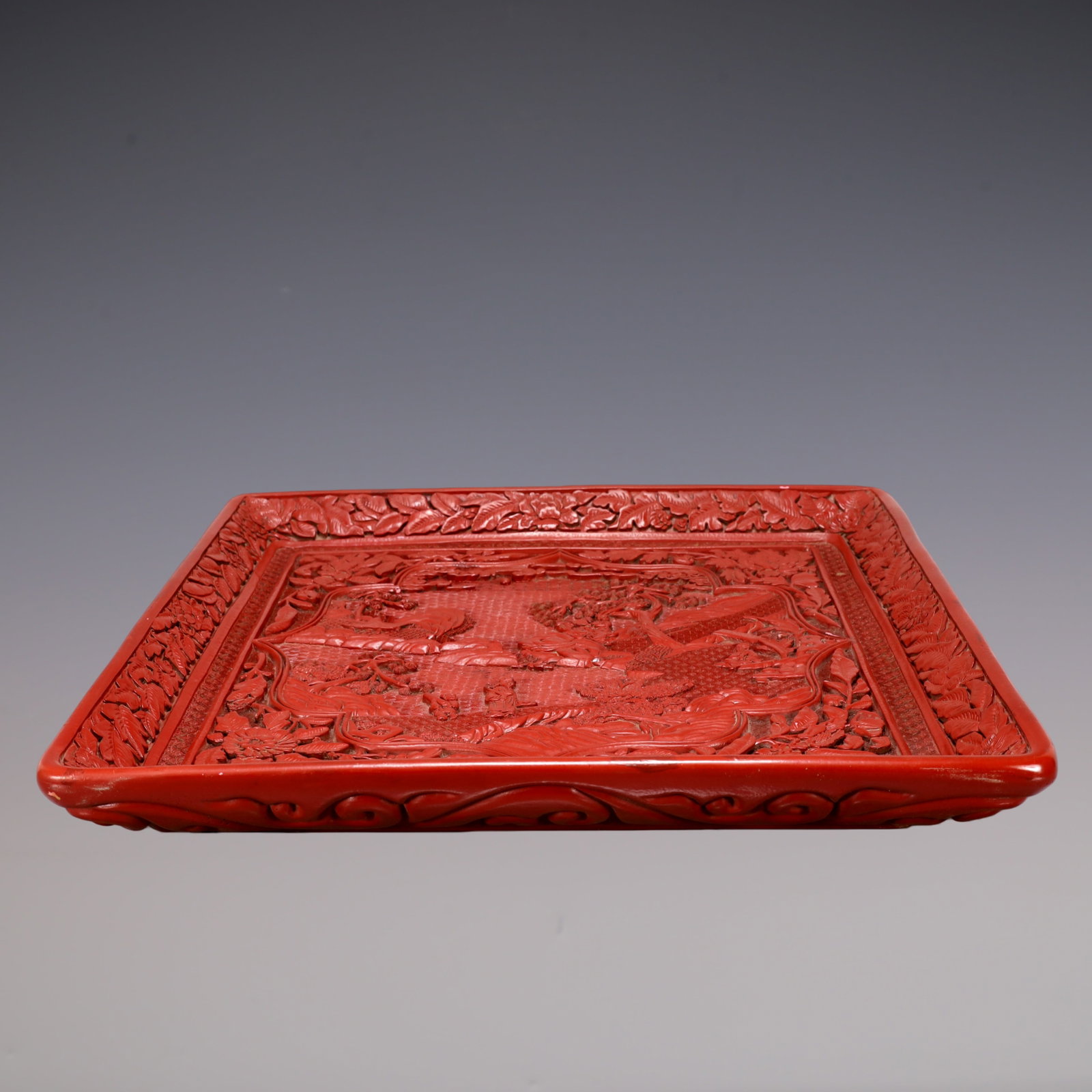 A Exquisite Carved Red Lacquer Landscape and Figure Pattern Plate: A Exquisite Carved Red Lacquer Landscape and Figure Pattern Plate Qing Dynasty, China Qianlong Six-character Mark Size:46cmx46cmx6cm Weight:2100g (The Dimensions Of All Batches Are Manually Measured.I