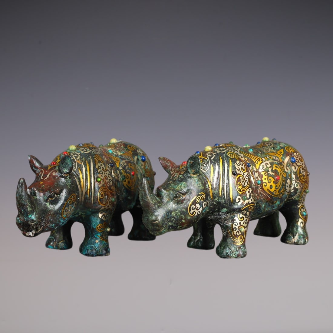 A Pair of Exquisite Bronze Inlaid Gold Inlaid Gems Rhinoceros Ornament: A Pair of Exquisite Bronze Inlaid Gold Inlaid Gems Rhinoceros Ornament Han Dynasty, China Size:27cmx12.5cm Weight:5110g (The Dimensions Of All Batches Are Manually Measured.If You Need More Detailed I