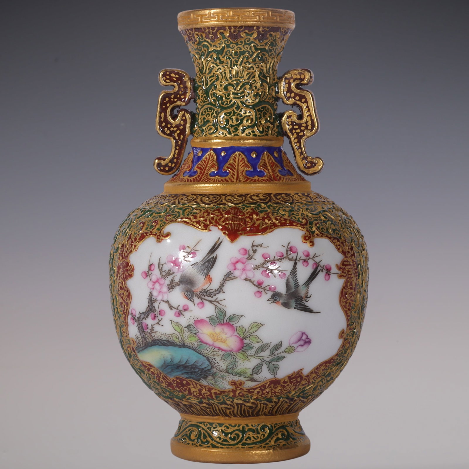 An Exquisite Enamel Green Ground Painted Gold Flower and Bird Pattern Double-Ears Vase: An Exquisite Enamel Green Ground Painted Gold Flower and Bird Pattern Double-Ears Vase Qing Dynasty, China Qianlong Four-character Mark Size:13.6cmx7.6cm (The Dimensions Of All Batches Are Manually Me