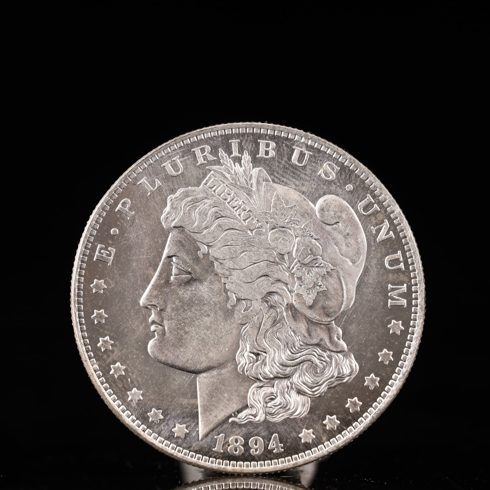 USA Morgan Dollar 1894 Coin: Obv: profile bust with date below and E PLURIBUS UNUM legend and stars around. Rev: eagle with In God we trust above within wreath with UNITED STATES OF AMERICA ONE DOLLAR legend. IN GOD WE TRUST / LI