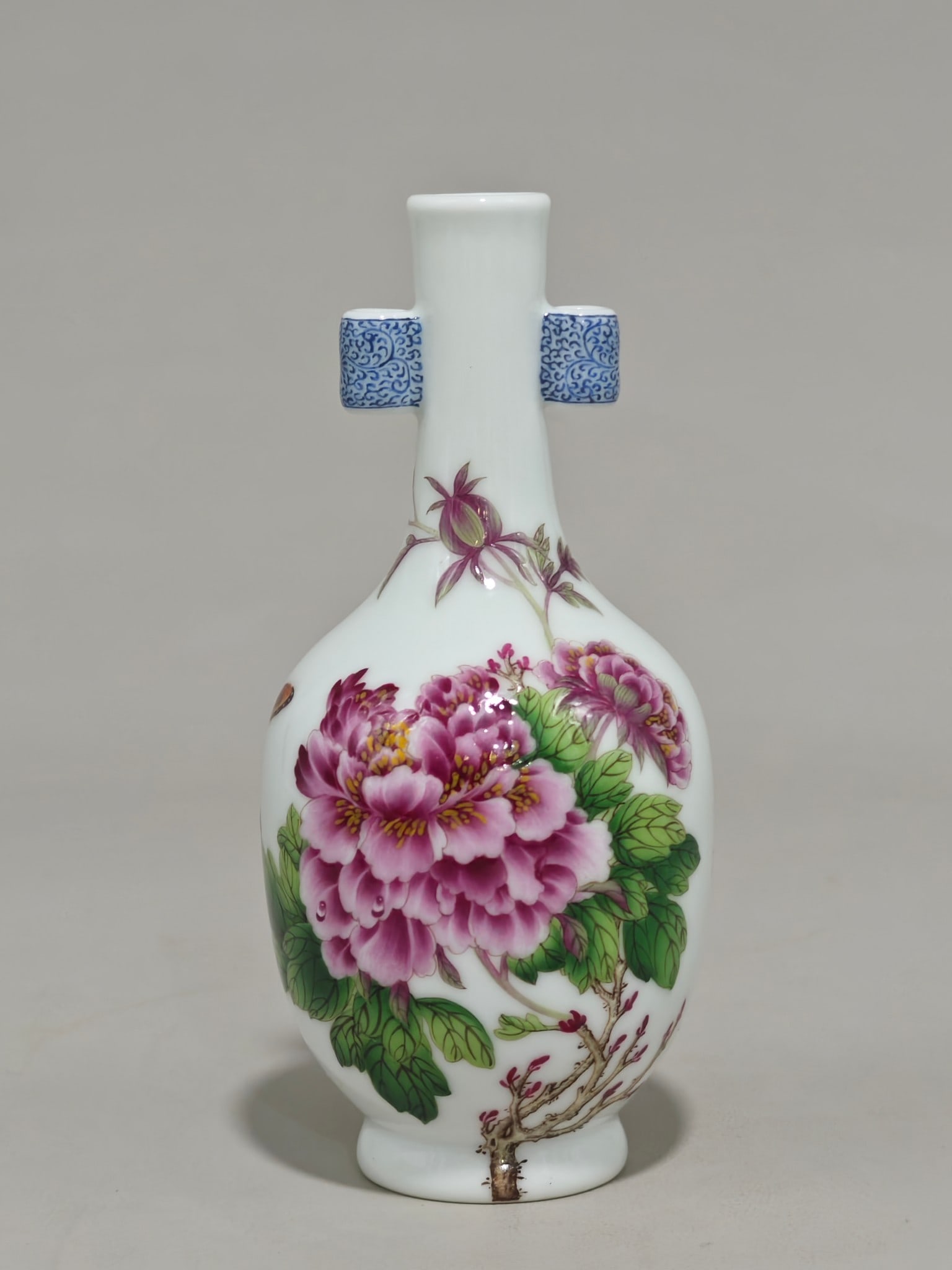 An Exquisite Enamel Flower and Butterfly Pattern with poem Double-Ears Vase: An Exquisite Enamel Flower and Butterfly Pattern with poem Double-Ears Vase Qing Dynasty, China Qianlong Four-character Mark Size:15cmx7.5cm (The Dimensions Of All Batches Are Manually Measured.If You