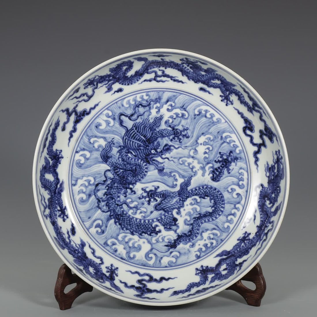A Ming Dynasty Xuande blue and white seawater dragon pattern plate: Ming Dynasty Xuande blue and white sea dragon pattern plate SIZE: H:6cm D:31cm (The Dimensions Of All Batches Are Manually Measured.If You Need More Detailed Information, Please Contact Our Customer