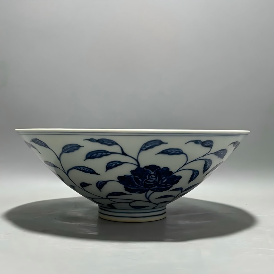 A Ming Dynasty Yongle blue and white entwined flower pattern bucket bowl: Ming Dynasty Yongle blue and white entwined flower pattern bucket standing bowl SIZE: H: 8.5cm MouthD: 22cm Bottom 6.8cm (The Dimensions Of All Batches Are Manually Measured.If You Need More Detailed 