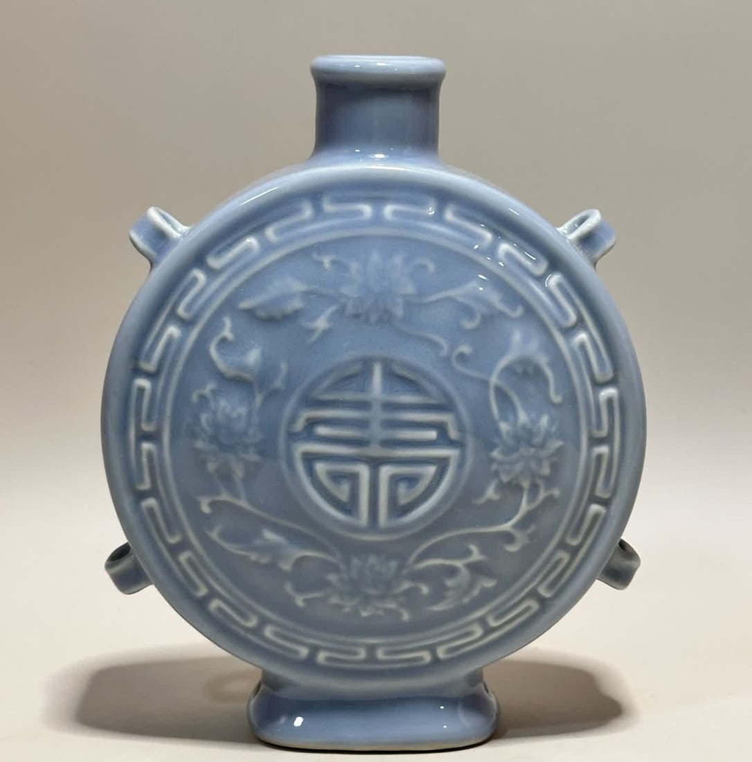A Qianlong era of the Qing Dynasty sky blue glaze Fulu Mianbian flat bottle: Qianlong year of the Qing Dynasty Sky blue glaze Fulu Mianbian flat bottle SIZE: H: 19.2cm MouthD: 3.7cm Bottom diameter 7.1cm (The Dimensions Of All Batches Are Manually Measured.If You Need More Det