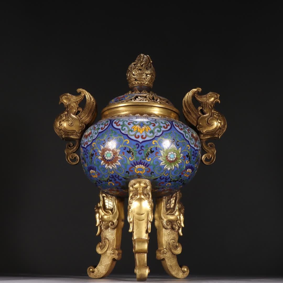 A Qing Dynasty copper gilt cloisonneentwined lotus pattern double phoenix ear three-legged aroma: Qing Dynasty copper gilt cloisonneentwined lotus pattern double phoenix ears three-legged aromatherapy stove SIZE: H:30.5cm W:22.2cm W:3521.9g (The Dimensions Of All Batches Are Manually Measured.If Y