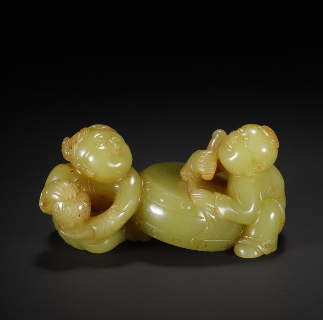 A Qing Dynasty Hetian topaz boy drumming ornament (1 of 11)