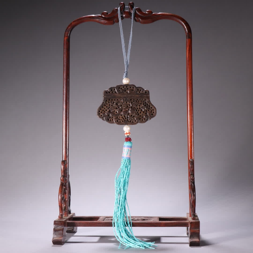 A Qing Dynasty agarwood hollow carving of three sachet pendants (1 of 9)