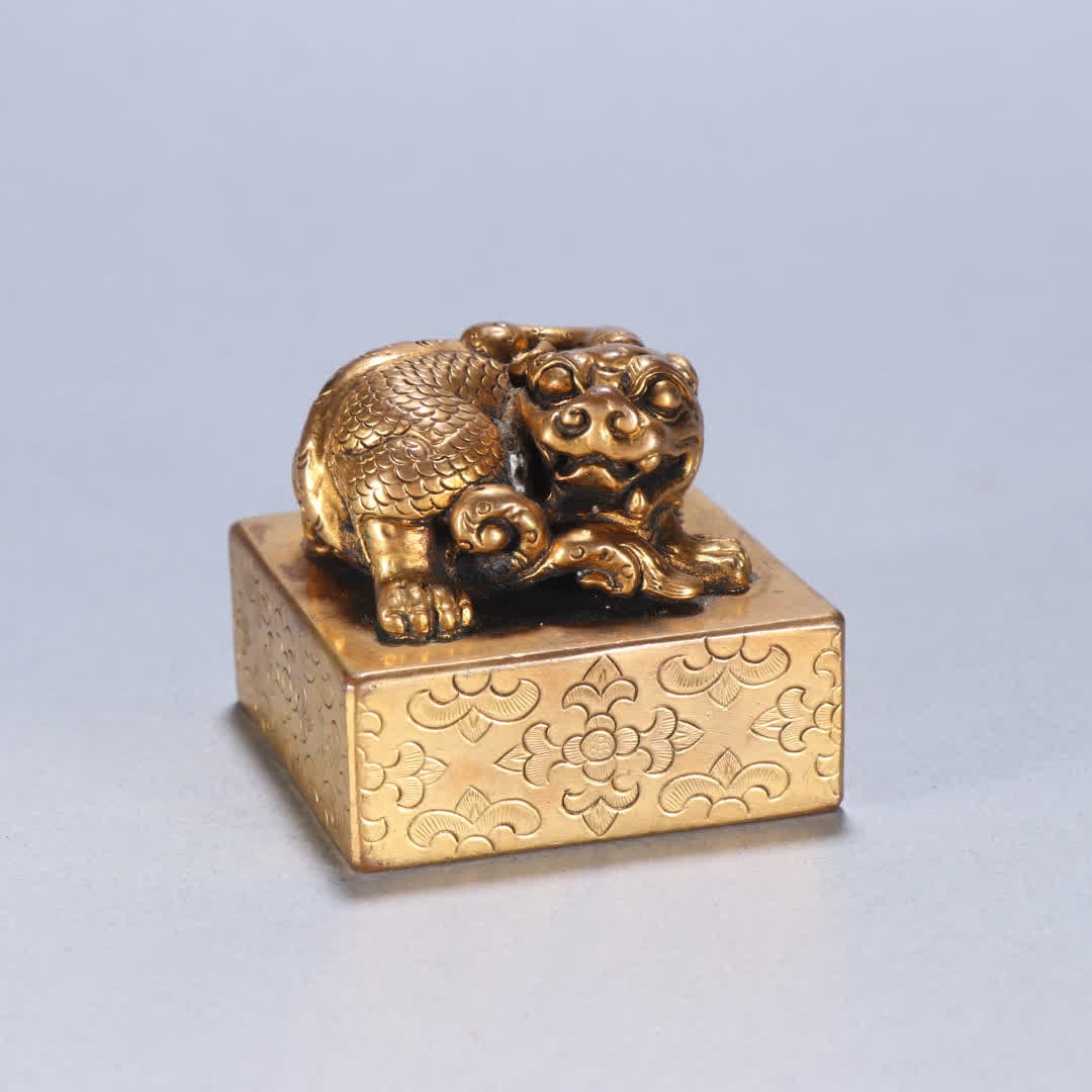 A Qing Dynasty copper gilt auspicious beast button seal (1 of 9)