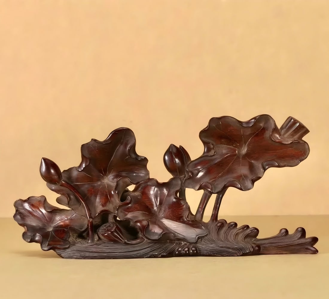 A Qing Dynasty Hainan Huanghuali ornament: Qing Dynasty Hainan Huanghuali Ornament According to the growth form of Huanghuali wood, cleverly conceived and carved, with lotus as the theme, the carving is meticulous, the lotus leaves are fat, th