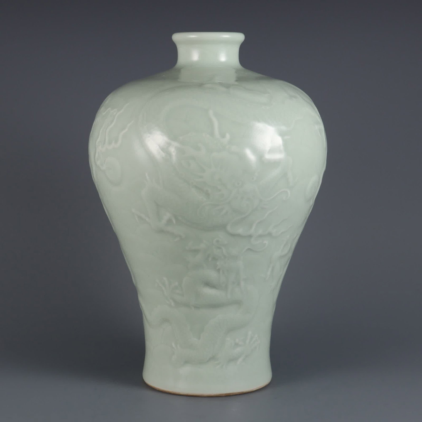 A Qing Dynasty Qianlong year powdered celadon carved seawater cloud dragon pattern plum bottle: Qing Dynasty Qianlong year powder blue glaze carved seawater cloud dragon pattern plum bottle SIZE: H:33cm MouthD:6.5cm (The Dimensions Of All Batches Are Manually Measured.If You Need More Detailed I