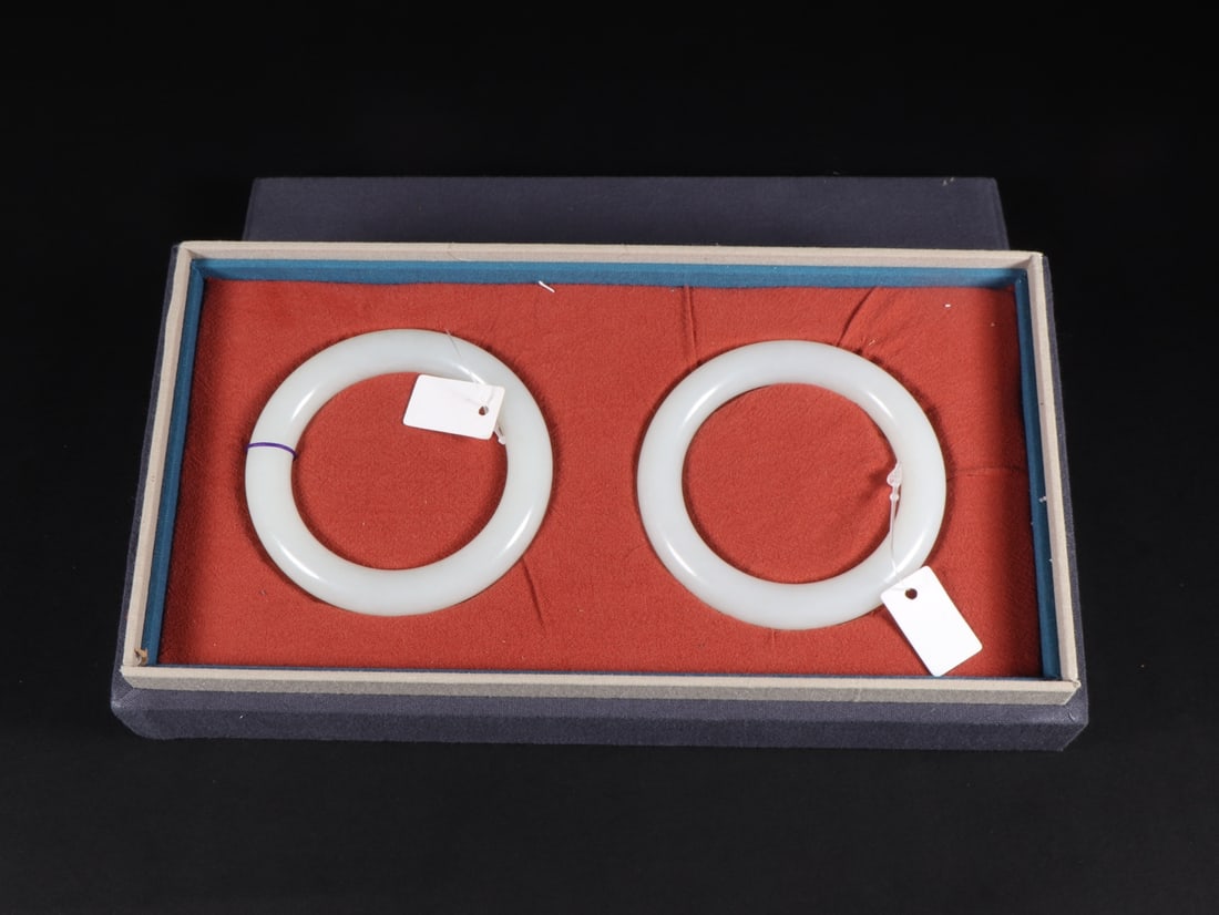A Pair of Exquisite White Jade Bracelets: A Pair of Exquisite White Jade Bracelets Qing Dynasty, China Size:(inside diameter)5.64cm Diameter Size:8cm Weight:70g Size:(inside diameter)5.7cm Diameter Size:8cm Weight:67g (The Dimensions Of All B