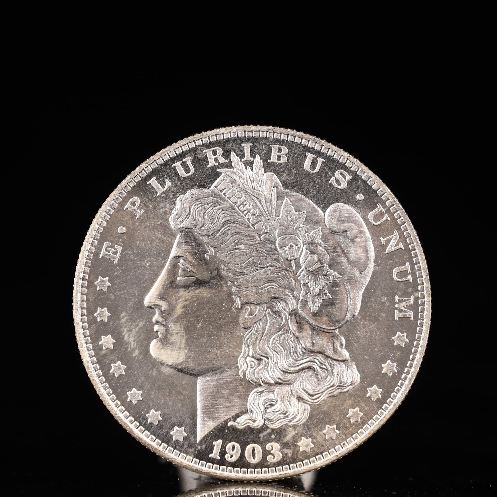 USA Morgan Dollar 1903 Coin: Obv: profile bust with date below and E PLURIBUS UNUM legend and stars around. Rev: eagle with In God we trust above within wreath with UNITED STATES OF AMERICA ONE DOLLAR legend. IN GOD WE TRUST /