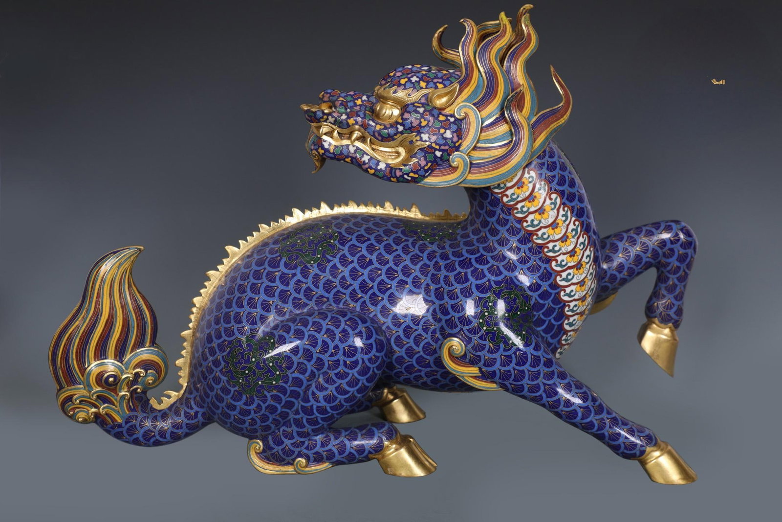 A beautiful Qing Dynasty finely cast bronze-bodied cloisonn?? enamel qilin ornament: Qing Dynasty finely cast bronze-inlaid cloisonne enamel qilin ornamentsSIZE:H:42cm L:59cm W:18cm W:13.95kg(The Dimensions Of All Batches Are Manually Measured.If You Need More Detailed Information, Pl