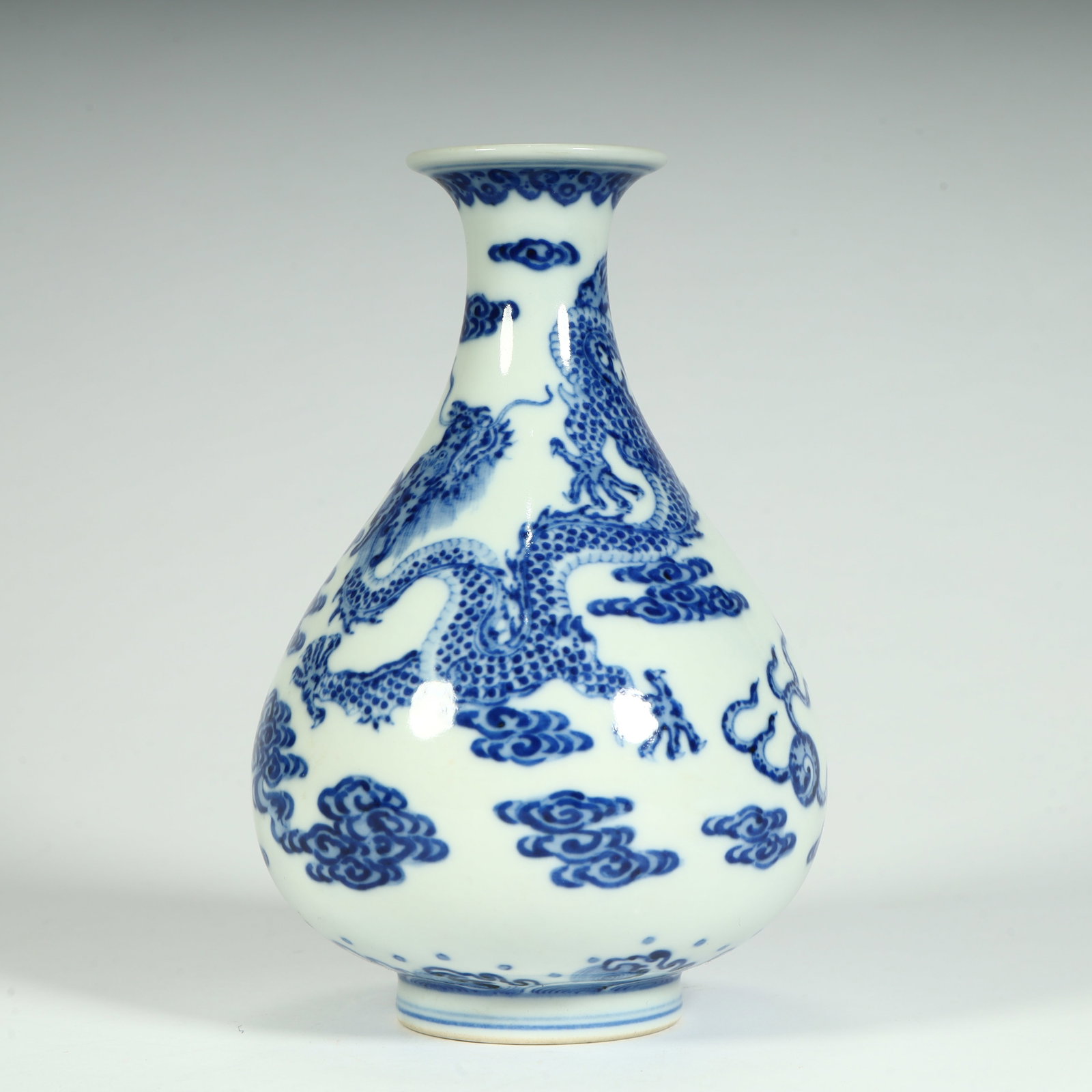 A fine Qing Dynasty Qianlong period jade bottle with cloud and dragon motif in blue and white jade (1 of 9)