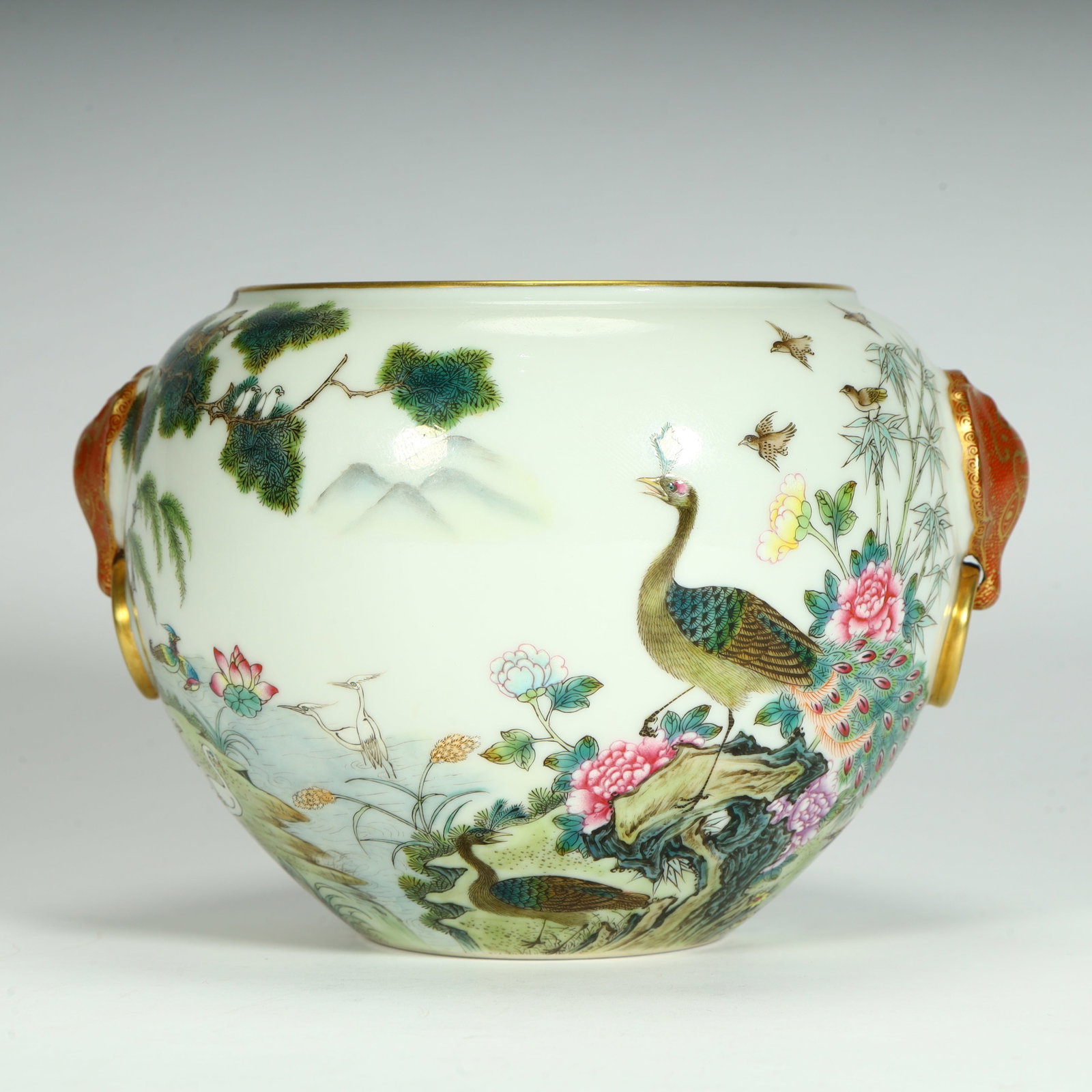 A fine Qing dynasty famille rose jar with a hundred birds and phoenix motifs at the head holding a (1 of 12)
