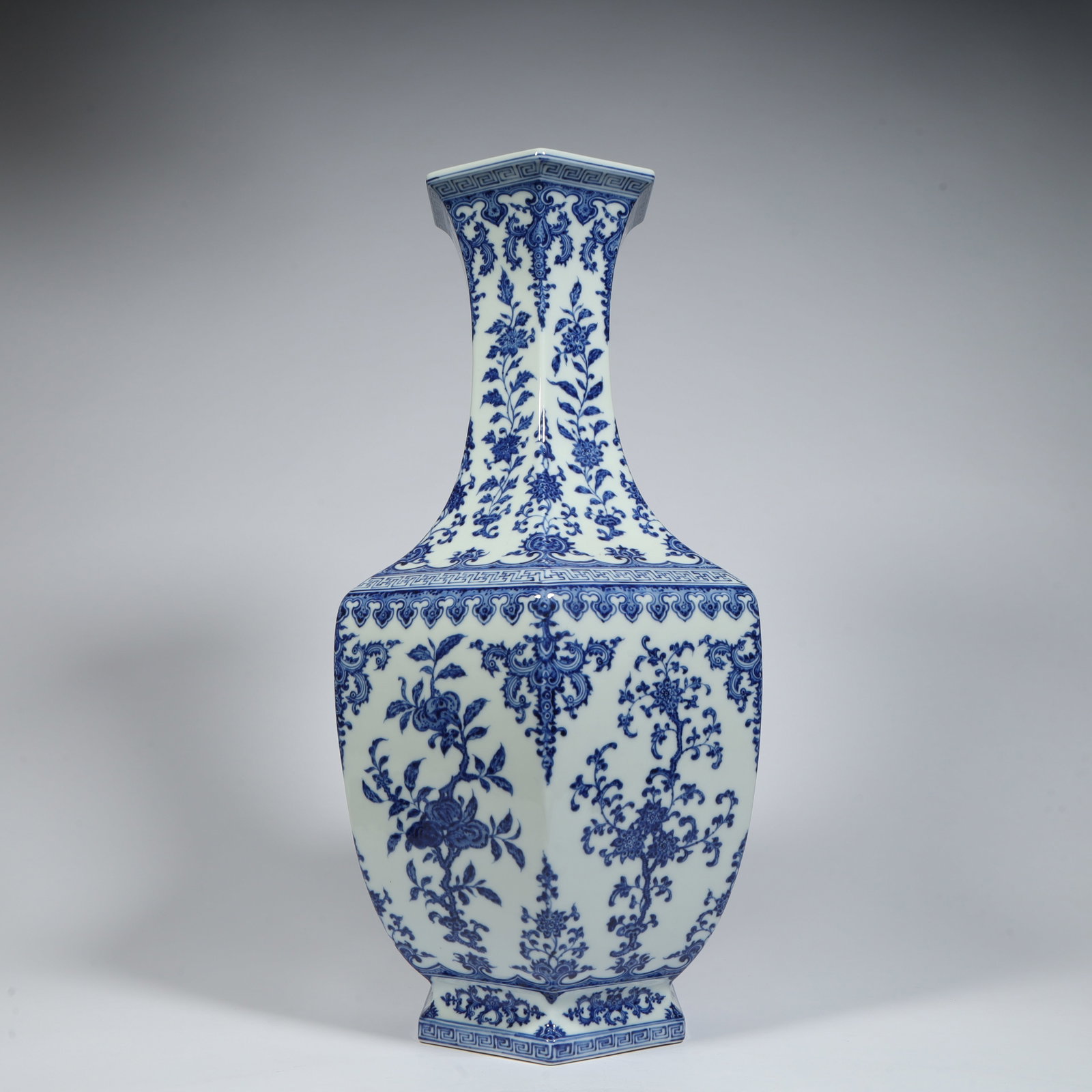 A beautiful Qing Dynasty Qianlong period blue-and-white hexagonal long-necked vase with entwined: Qing Dynasty Qianlong period blue-and-white hexagonal long-necked vase with entwined floral patternsSIZE:H: 47cm L: 20cm W: 20cm W: 5.4kg(The Dimensions Of All Batches Are Manually Measured.If You Nee
