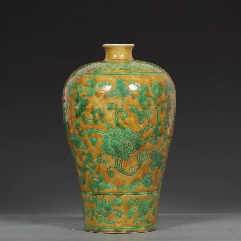 A fine Ming Dynasty Yongle yellow ground green-painted entwined lotus plum vase: Ming Dynasty Yongle Yellow Ground Green Lotus Pattern Plum Vase with Entwined BranchesSIZE:H:25cm D:4.2cm D:15.5cm(The Dimensions Of All Batches Are Manually Measured.If You Need More Detailed Informa
