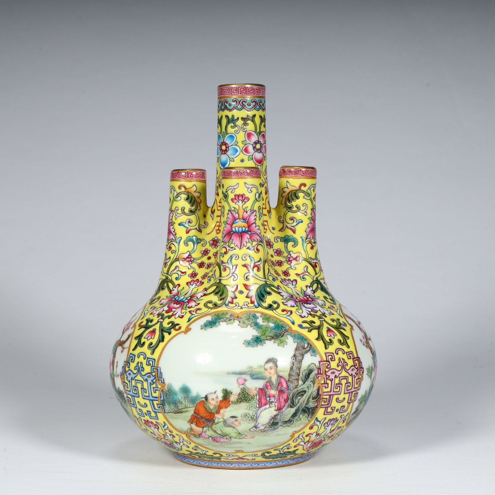 A fine Qing Dynasty Qianlong period yellow ground famille rose entwined floral consecration and: Qing Dynasty Qianlong Period Yellow Ground Famille Rose Entwined Floral Five-Hole Vase with Flower-Consecrated Parenting SceneSIZE:H: 18cm L: 11.5cm W: 11.5cm W: 543g(The Dimensions Of All Batches Are