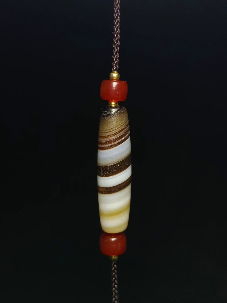 A fine ancient silk-reeling agate bead from the Qing Dynasty (1 of 3)