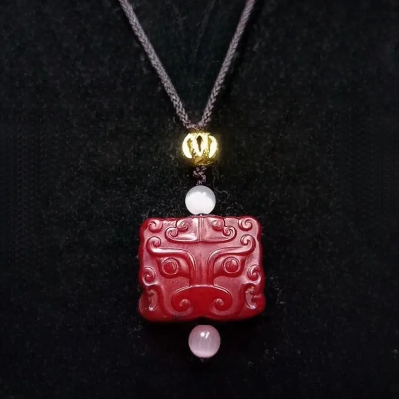 A fine Han Dynasty old Hetian red jade pendant with Taotie beast face motif: Han Dynasty old Hetian red jade taotie beast-face pendantSIZE:L:2cm(The Dimensions Of All Batches Are Manually Measured.If You Need More Detailed Information, Please Contact Our Customer Service Befor