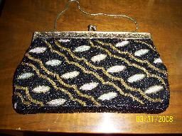 VINTAGE BLACK WHITE AND GOLD BEADED BAG: NICE VINTAGE BEADED BAG WITH A NICE ART DECO BEADED DESIGN BLACK BACKGROUN WITH GOLD LINES AND WHITE OVALS BRASS FRAME 9 1/2 X 6 INCHES
