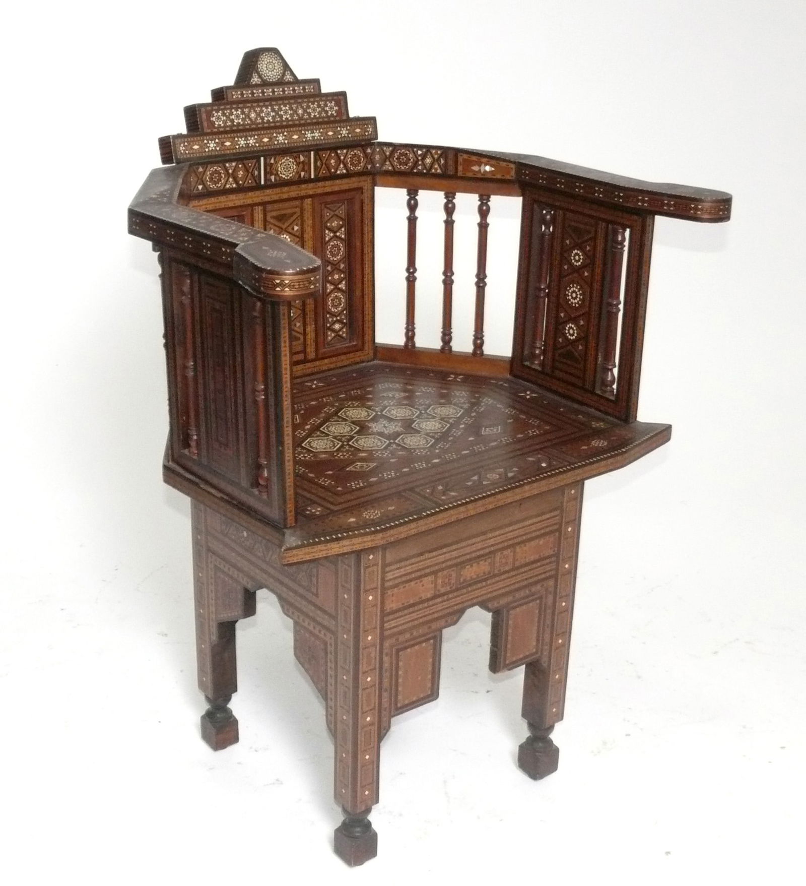 Inlaid Moroccan Chair: Inlaid Moroccan chair, in the manner of Carlo Bugatti, Moroccan, circa 1950s. Completely hand made with intricate inlay throughout. Retains warm original patina. 35.25"H x 25.25"W x 17.5"D x 18.75" se