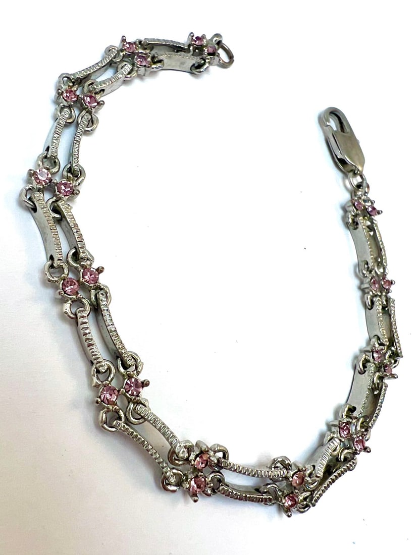 Silver-Tone Bracelet with Pink Rhinestones: Elegant vintage silver-tone bracelet featuring intricate linked metalwork accented with delicate pink rhinestones. The floral-inspired design gives it a romantic, antique charm. Finished with a secure