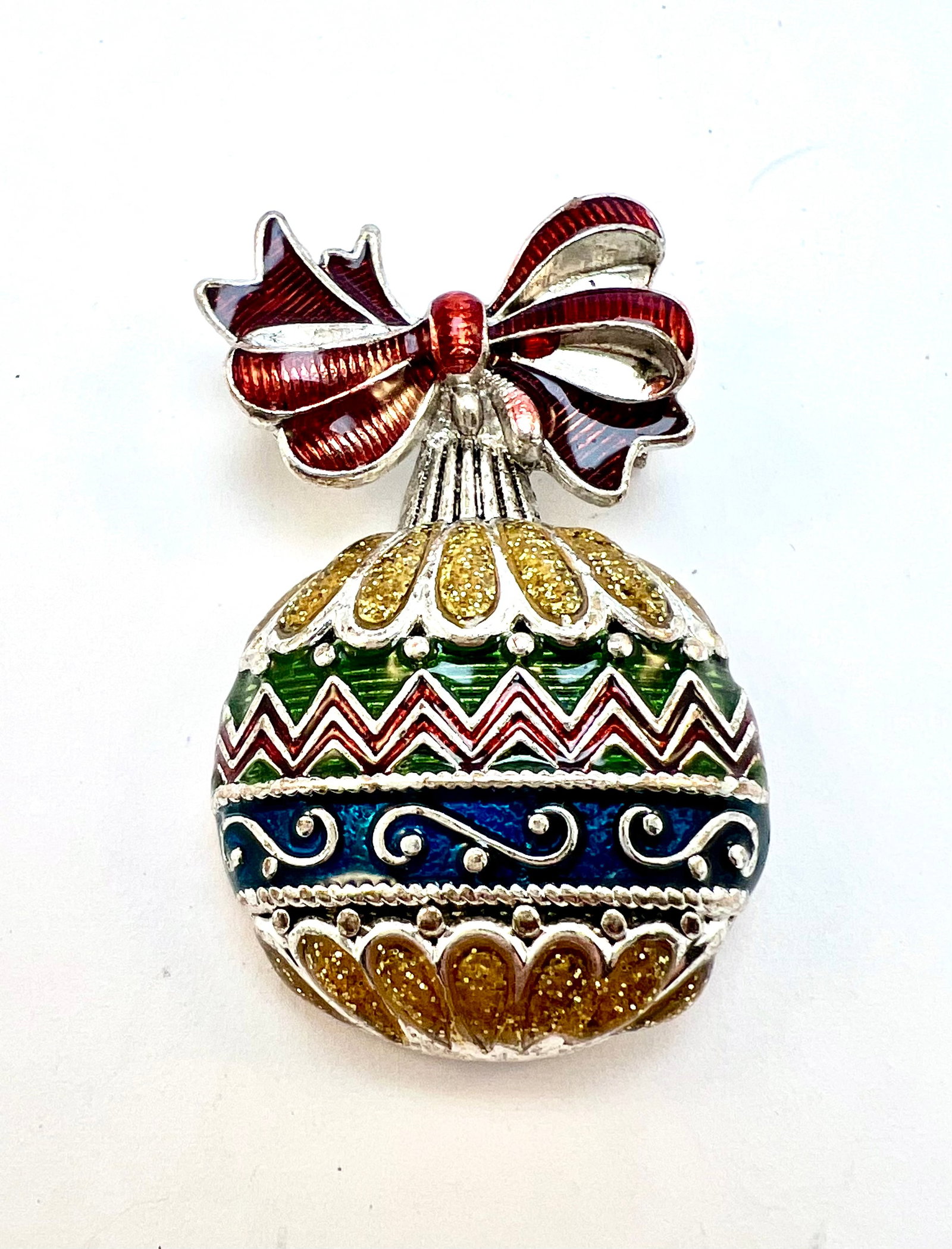 Enamel Christmas Ornament Brooch: Festive silver-tone brooch with colorful enamel, glitter details, and a red ribbon bow. Signed NP. Perfect for holiday wear or collecting.