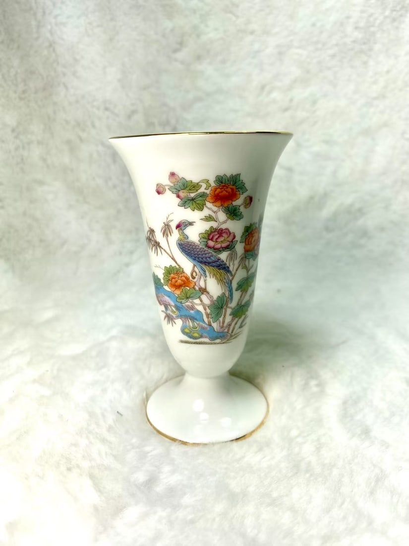 Wedgwood Bone China Bud Vase with Bird and Floral Motif, Made in England: This elegant bud vase by Wedgwood is crafted from fine bone china and features a delicate Eastern-inspired design of a peacock amid blooming peonies, bamboo, and water motifs. The gold-trimmed rim and