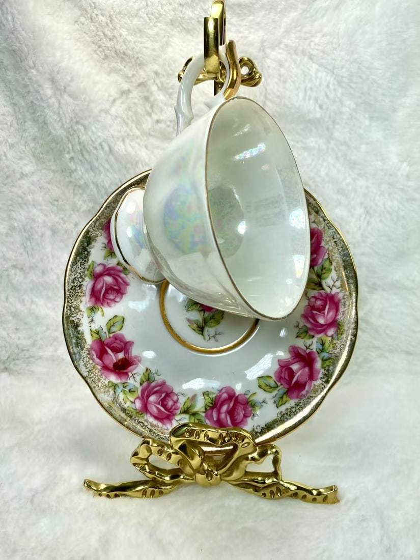 Japanese Lusterware Pink Rose and Chrysanthemum Cup and Saucer Set, Japan: A captivating Japanese lusterware tea cup and saucer set adorned with pink roses and vibrant chrysanthemums, featuring a delicate iridescent finish and gold accents. Made in Japan.