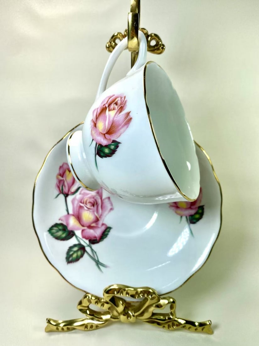 Royal Vale Fine Bone China Pink Rose & Gold Trim Tea Cup and Saucer Set - England: This charming fine bone china tea cup and saucer set by Royal Vale features a delicate pink rose motif with subtle gold trim, exuding a classic English elegance. The gold-lined rims and scalloped edge