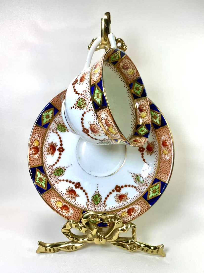 Colclough China Bone China Floral and Geometric Tea Cup and Saucer Set: A stunning tea cup and saucer set by Colclough China, crafted in bone china with intricate floral and geometric patterns in rich blue, green, and gold tones. A collector’s gem that encapsulates the
