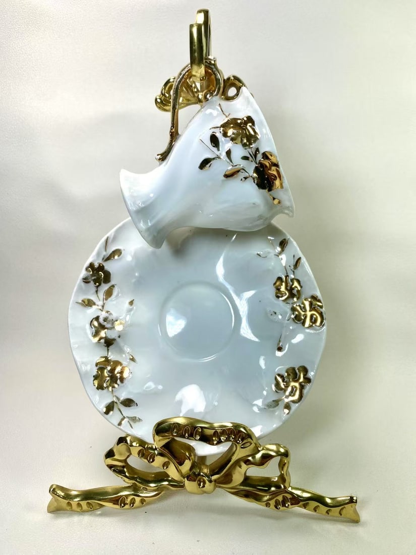 German Baroque Style Gilded Rose Embossed Tea Cup & Saucer Set | Red "GERMANY" Mark: This opulent German tea cup and saucer set features a striking Baroque-inspired design adorned with raised rose floral patterns and rich gold accents, exuding a sense of vintage luxury. The base is ma