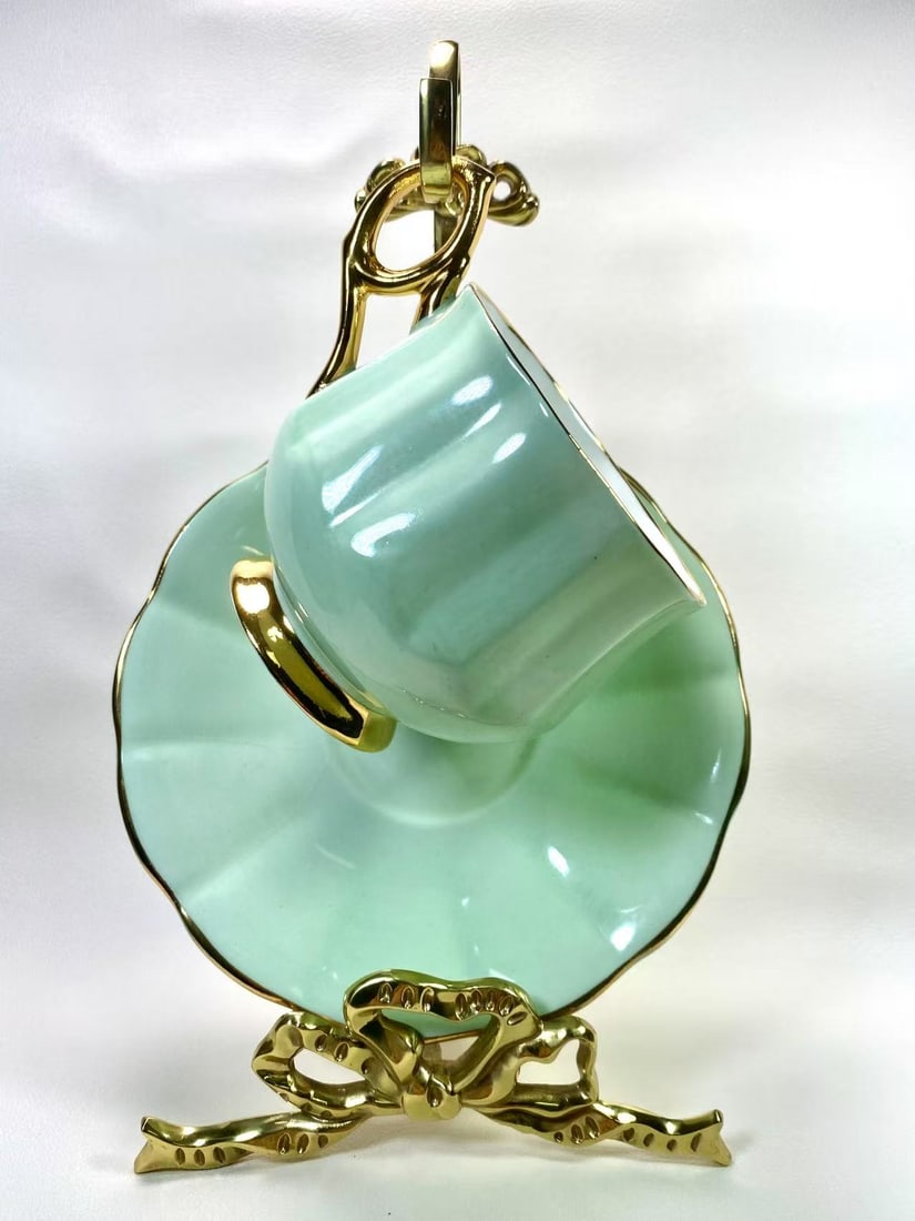 Rosina Mint Green Bone China Tea Cup & Saucer Set | Petal Shaped Design | Classic English Elegance: This charming tea cup and saucer set by Rosina England features a soothing mint green hue, accented with a delicate petal-shaped edge, exuding a timeless elegance. Marked with the Rosina logo and a re