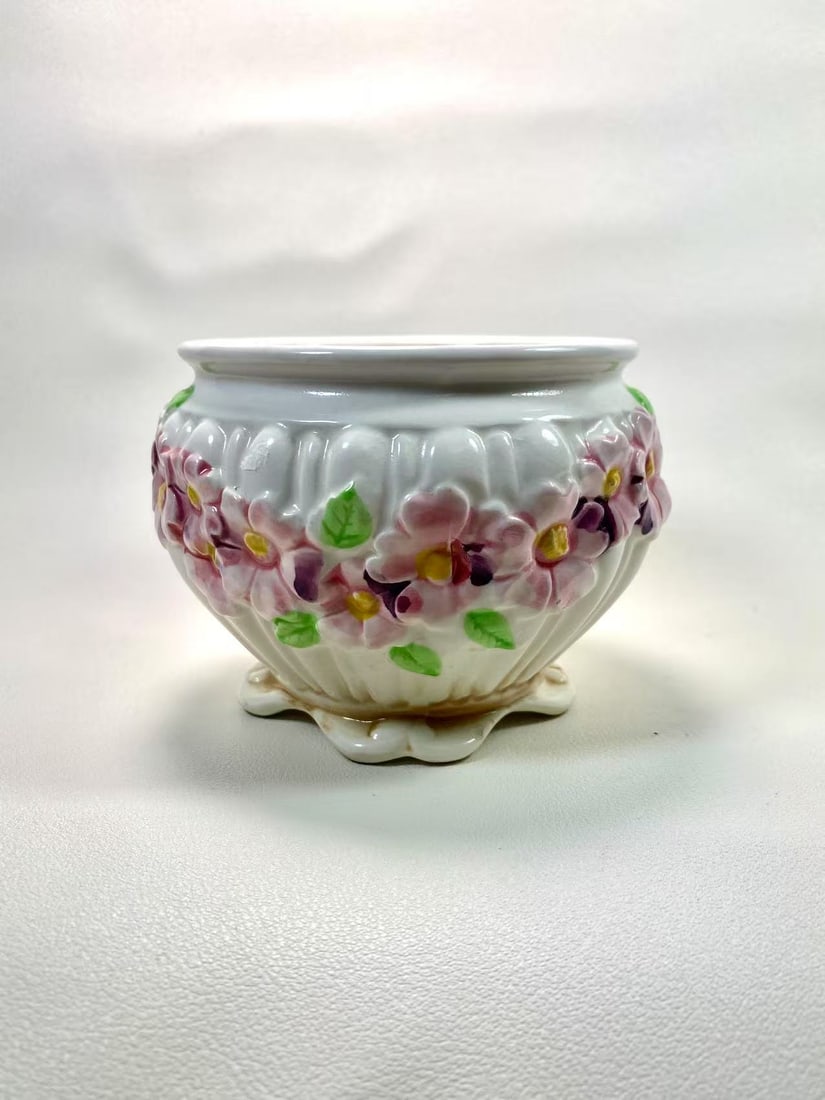 Capodimonte Italian Floral Relief Ceramic Vase — Shell Base Design: This exquisite ceramic piece by Capodimonte Italy features intricately crafted floral reliefs set against a delicate shell-shaped base. The soft pink and green floral motifs beautifully contrast with