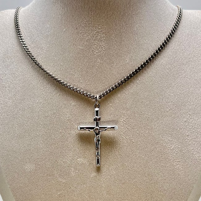 Vintage Sterling Silver Crucifix Necklace with Mark: A vintage sterling silver crucifix pendant featuring a dimensional corpus of Christ on a cylindrical cross. The surface is high-polish with defined sculptural details and smooth rounded ends. Reverse 
